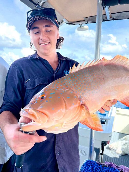 Angler holding Coral Trout